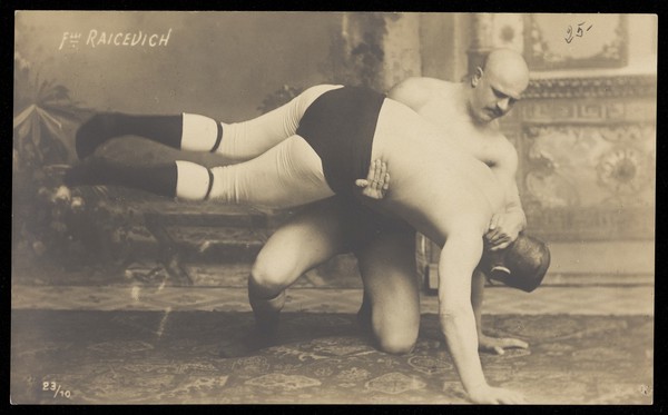 Two of the Raicevich brothers, wrestlers. Photographic postcard, 19--.