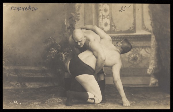 Two of the Raicevich brothers, wrestlers. Photographic postcard, 19--.