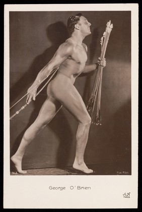 George O'Brien posing holding a bow and arrows. Photographic postcard, 192-.