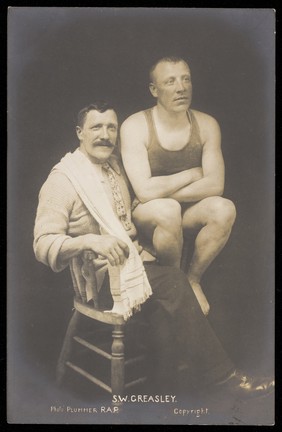 S.W. Greasley (right), champion swimmer, with his trainer (?). Photographic postcard, 19--.