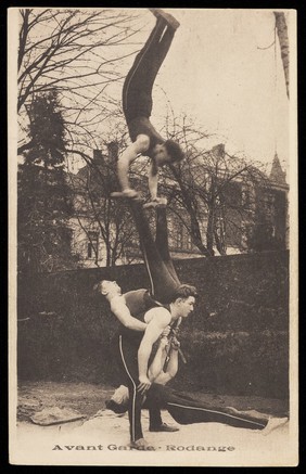 Four acrobats performing outdoors in Luxembourg. Process print, 192-.