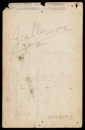 A wrestler flexing his biceps. Photographic postcard, 19--.