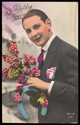 A man holding flowers and a horseshoe; representing a romantic new year. Coloured photographic postcard, 192-.