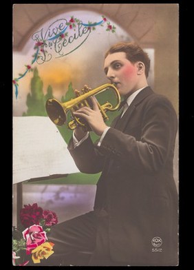 A man holding a trumpet, with flowers, celebrating Saint Cecilia's day. Coloured photographic postcard, 1931.