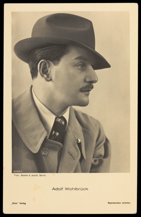 Adolf Wohlbrück (Anton Walbrook), in profile, wearing a trilby. Photographic postcard by Bender & Jacobi, 193-.