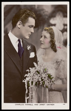 Charles Farrell and Janet Gaynor, as bride and groom. Coloured photographic postcard by Fox, 193-.