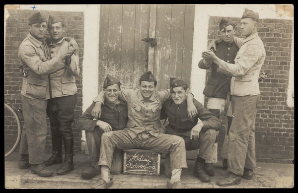 Belgian military recruits celebrating the end of their training stint at Camp Beverlo. Photographic postcard, 192-.