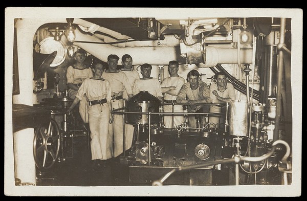 Sailors posing in an engine room. Photographic postcard, 191-.