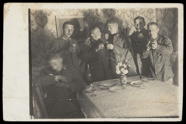 German soldiers enjoying a drink in a dining room. Photographic postcard, 190-.