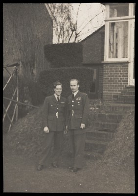 Michael Simon and Gerald Fidler, two air force officers, together in a garden. Photograph, 1943.