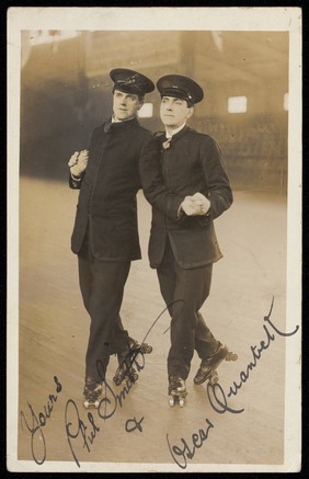 Phil Smith and Oscar Quantrell in uniform perform a roller-skating act arm-in-arm. Photographic postcard, 192-.