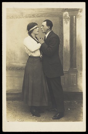 Two men embracing during a theatrical performance.