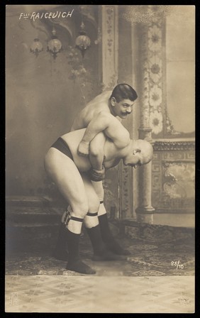 Two of the Raicevich brothers, wrestlers. Photographic postcard, 19--.