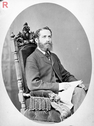 Arthur Schuster, seated, facing left, aged about 38. Photograph by L. Suscipi, c. 1888.