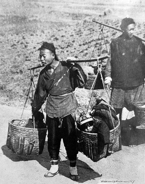 view Chinese baby carriage: a market basket slung on a pole