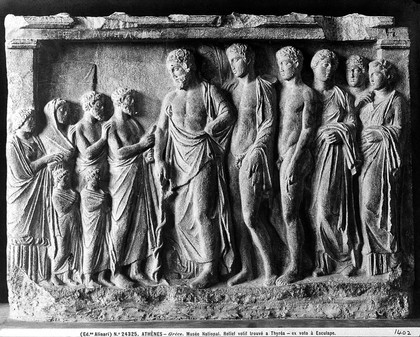 Aesculapius with his sons Podalairius and Machaon and three daughters - with supplicants. Greek relief found at Thyrea. At National Museum Athens.