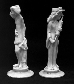 Candlesticks: One figure has an enema; the other has a stomach ache.