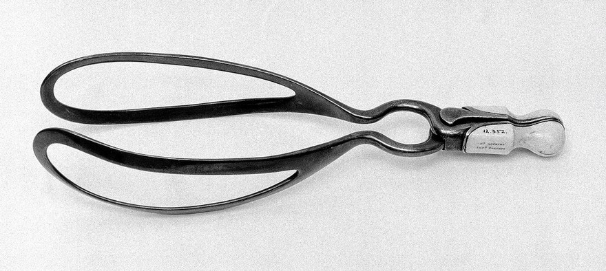 'Dr Hopkins' improved obstetrical forceps. Forceps with short handles finger ring and pelvic curve.