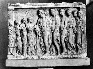 view Relief in form of a shrine: centre Asklepios; behind him his two doctor sons Podalerios and Machaon; his 3 daughters: Iaso, Akeso and Panakeia. Opposite 4 worshippers, in first plan 2 youths. Behind drawn the head of a maid-servant, with a basket of offerings on her head. At feet of god a sacrificial pig.