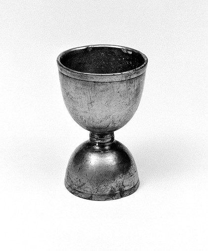 Double egg-cup of pewter.