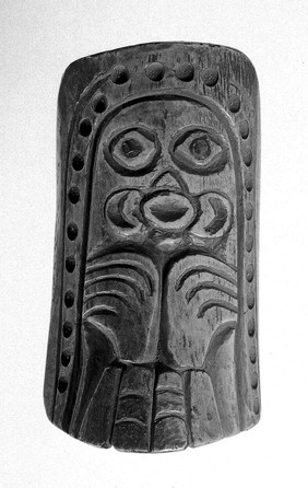 Shaman's charm of bone carved in Totemic British Columbia. North West Coast of America. Designs representing the Octopus and anthropoozomorphic bird. Abalone inlays in eyes. Hole pierced at top for pendant.