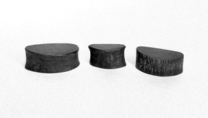 view Three wooden semi circular labrets (lip plugs), from N.W. coast of Africa. Semi-circular, grooved, worn in lower lip.