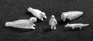 view Four carved ivory amulets, Eskimo.