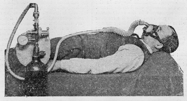 Man with appuratus for administering oxygen.