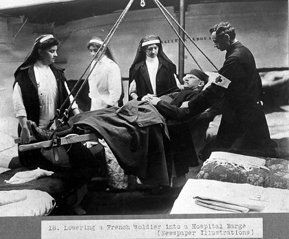 World War One; lowering a soldier into a hospital barge