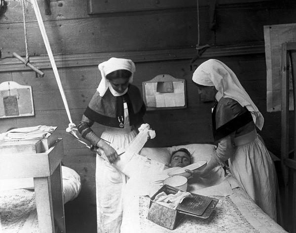 World War One, two nurses attending to a patient