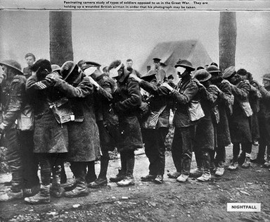 World War One: men with wounds to the eyes walking in a single line, each man placing his left hand on the left shoulder of the man in front for assistance. Captioned 'Nightfall.'