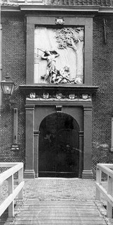 Doorway of the old pest house at Leiden, with a sculptured stone relief above, dated 1660. Photograph.