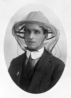 view Postcard: mosquito net to be worn as a veil.