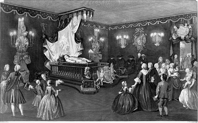 The lying in state of Willem IV, Prince of Orange-Nassau, surrounded by his grieving family and servants. Line engraving with etching by J. Punt after P. De Swart, 1752.