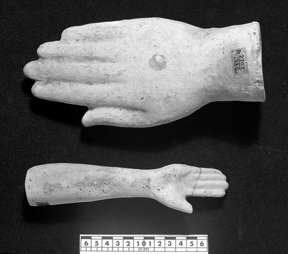 Votive offerings in the form of the hand and forearm. Apparently terracotta.