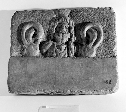 Marble votive plaque with relief bust, possibly Serapis.