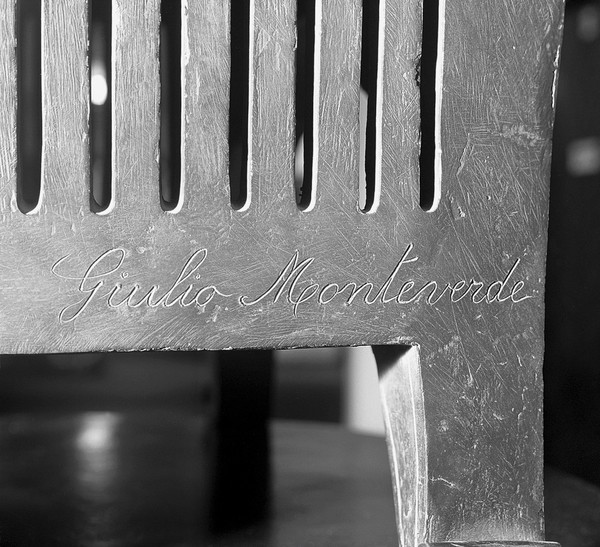 Bronze statue: Jenner vaccinating a young child; detail: signature of Monteverde