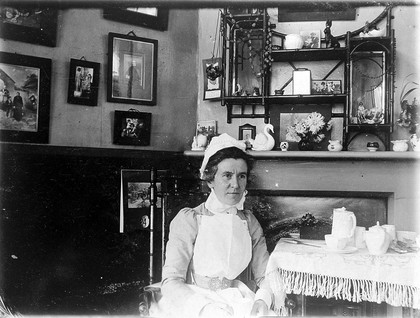 St Bartholomew's Hospital, London: a nurse taking tea. Photograph, c.1890.