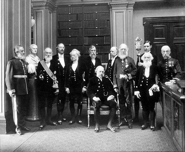 Fellows of the Royal Society: Sir John Evans, bust of Sir Isaac Newton, Lord Kelvin, R.B. Clifton, G.G. Stokes, Sir Michael Foster, Lord Lister, Arthur W. Rucker, Sir J.D. Hooker, Sir William Huggins, Sir W.T. Thiselton Dyer. Photograph by Mayall.