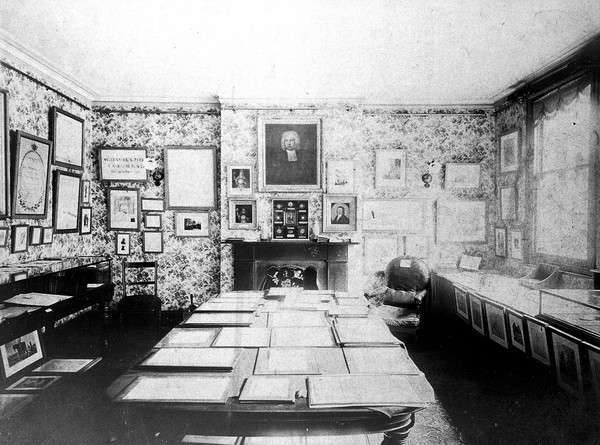 Room where Frederick Mockler's collection of Jenneriana was displayed; parts of which are seen on the walls and on the central table. Photograph.