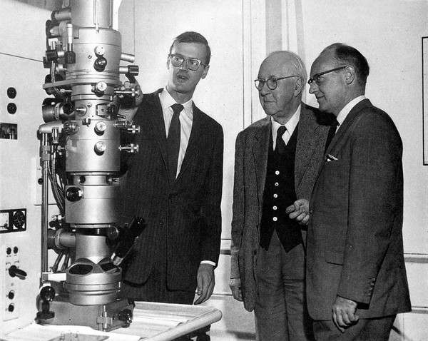 An electron microscope for McGill University, Canada. Dr. Birks demonstrates the instrument to Sir Henry Dale and Professor MacIntosh.