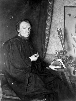 view Portrait of W. H. Dallinger, seated at r. to microscope, after restoration