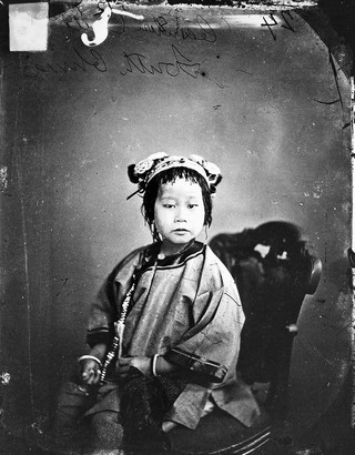 Chinese child seated, Canton, Kwangtung province, China