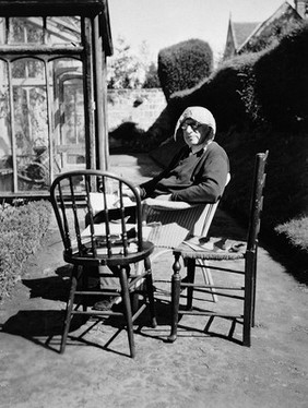 Lord Moran writing in garden, 1960s