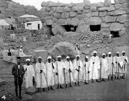 Guards outside House of Boulders, Jebel Moya site, Sudan