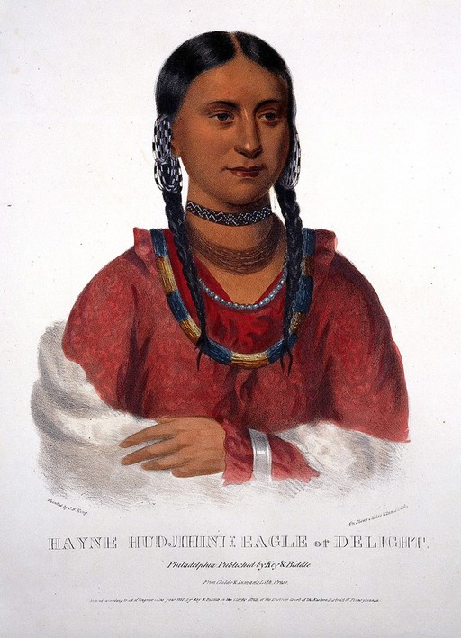 Hayne hudjihini: Eagle of delight, with plaits wearing a red dress, fur shawl, and numerous neck decorations.