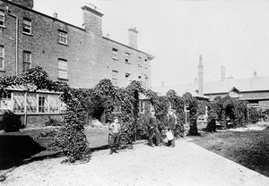 view Royal Portsmouth Hospital: the garden, with the gardeners. Photograph, 1902.