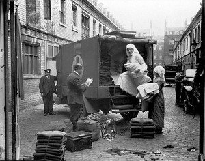 view Ambulance Column depot, 9 Gower Street, London: loading up the blanket bus in Gower Mews. Photograph, September 1918.