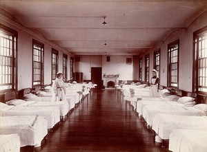 view Claybury Asylum, Woodford, Essex: a dormitory. Photograph by the London & County Photographic Co., [1893?].