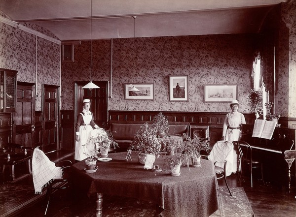 Claybury Asylum, Woodford, Essex: a social room (?) Photograph by the London & County Photographic Co., [1893?].